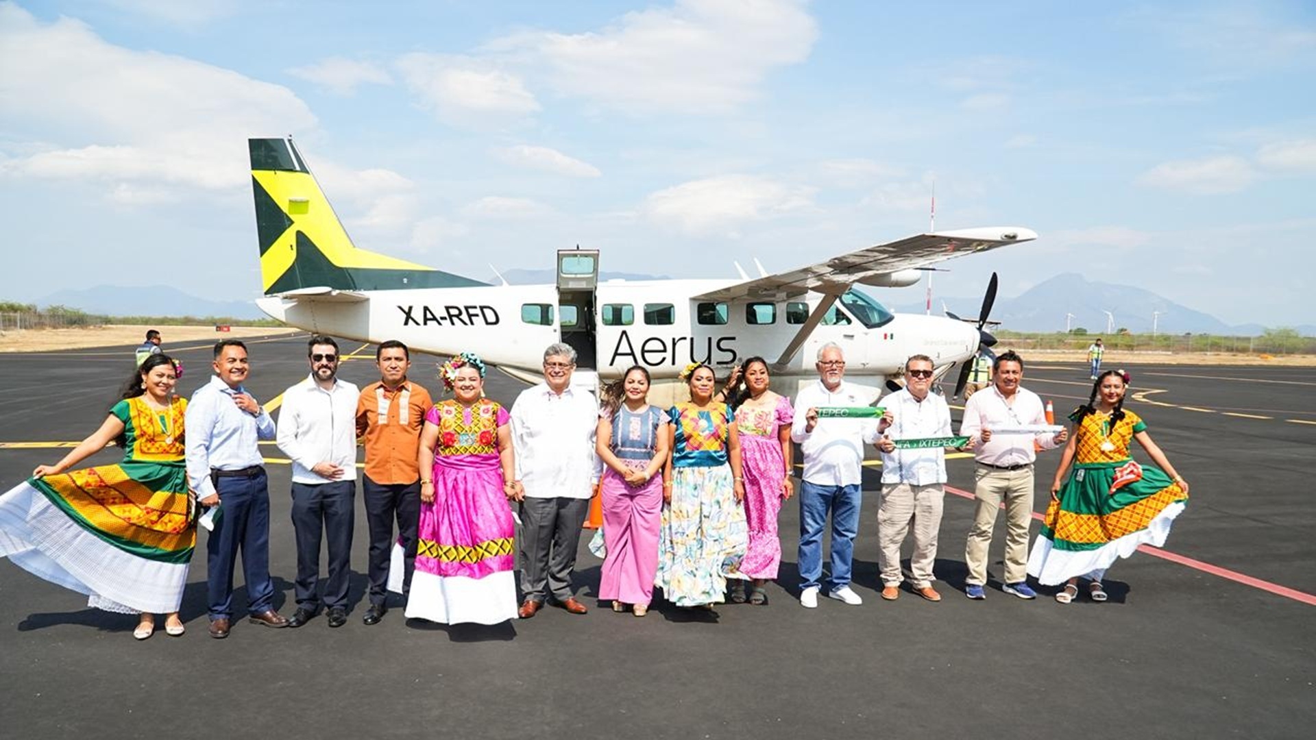 Avioneta de la aerolínea Fly Aerus en Ixtepec, Oaxaca, junto a diferentes personas sobre la pista.